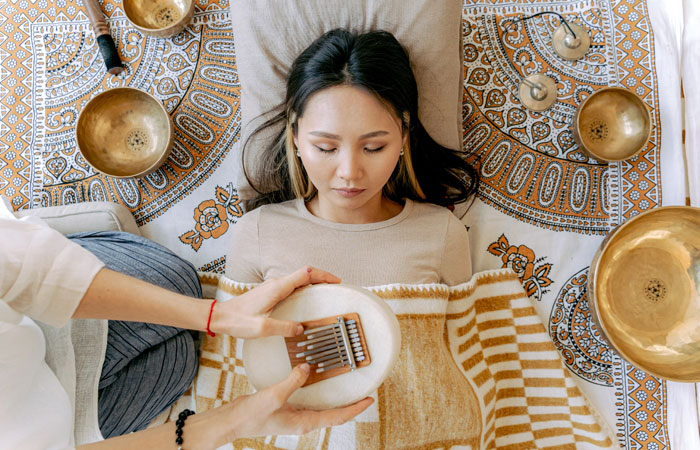 a woman relaxing in a sound bath